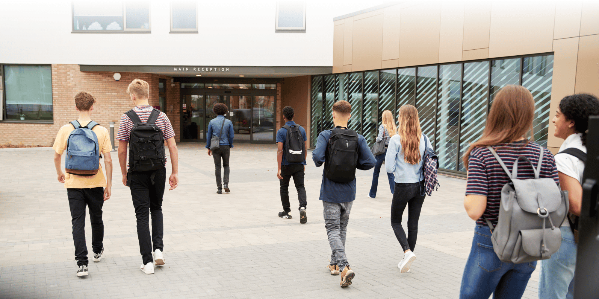 group of students walking into an education facility or college