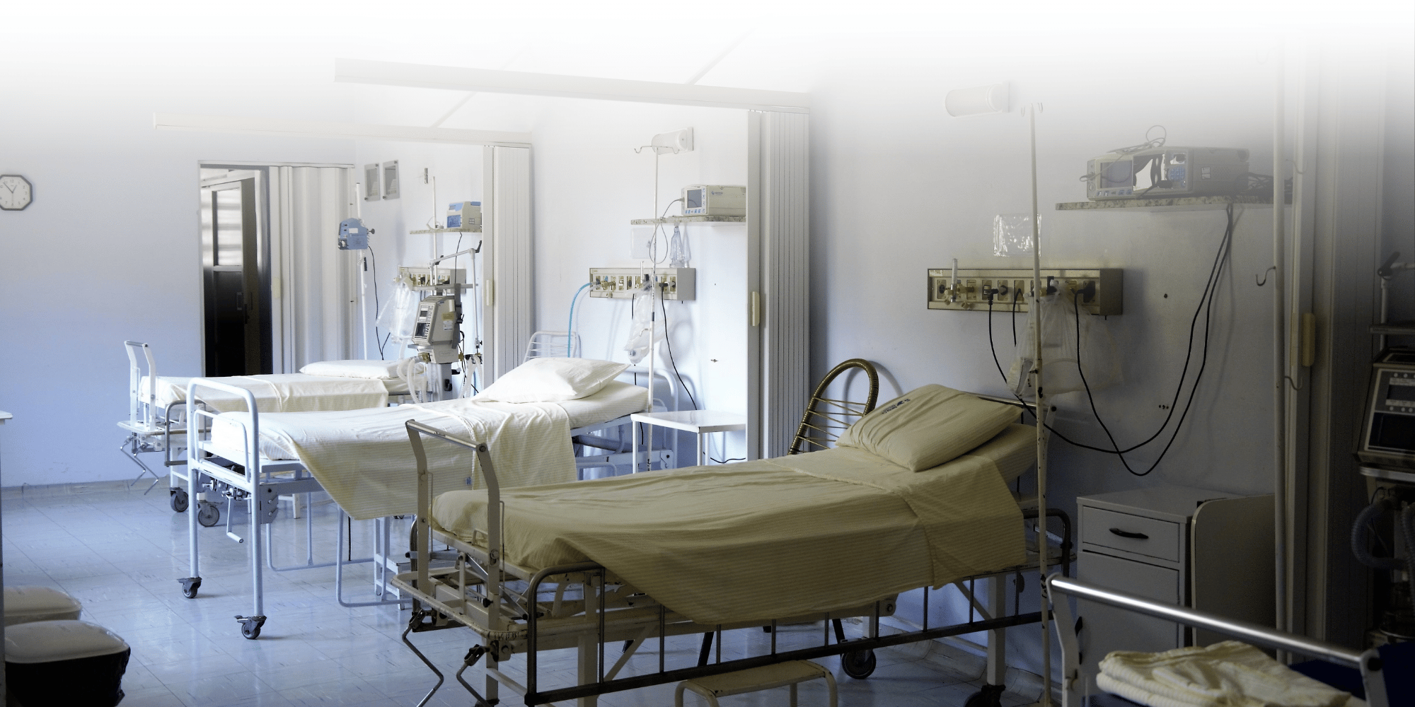 Row of Hospital beds with mixed lighting