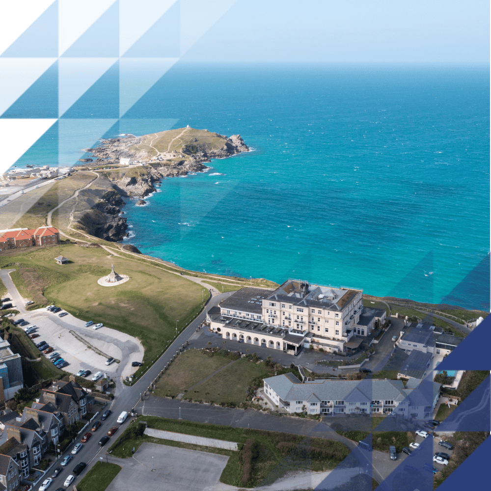 Hotel along a beach front surrounded by vast waters and other buildings - birds eye view overlayed with Hochiki triangle branding