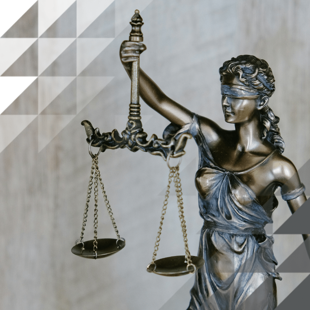 Bronze figurine of Lady Justice with scales, bronze in material against a grey background