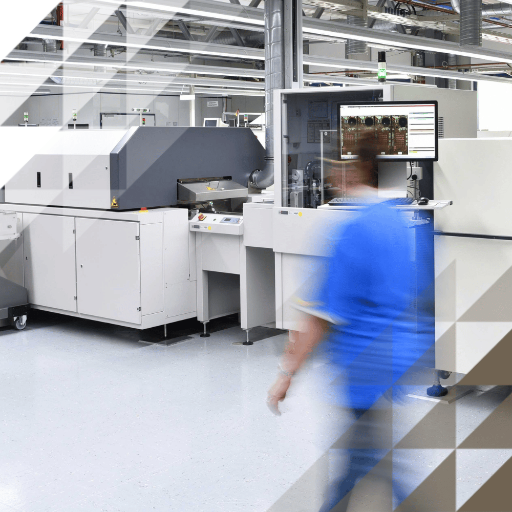 Large scale printing press with person blurred walking in frame