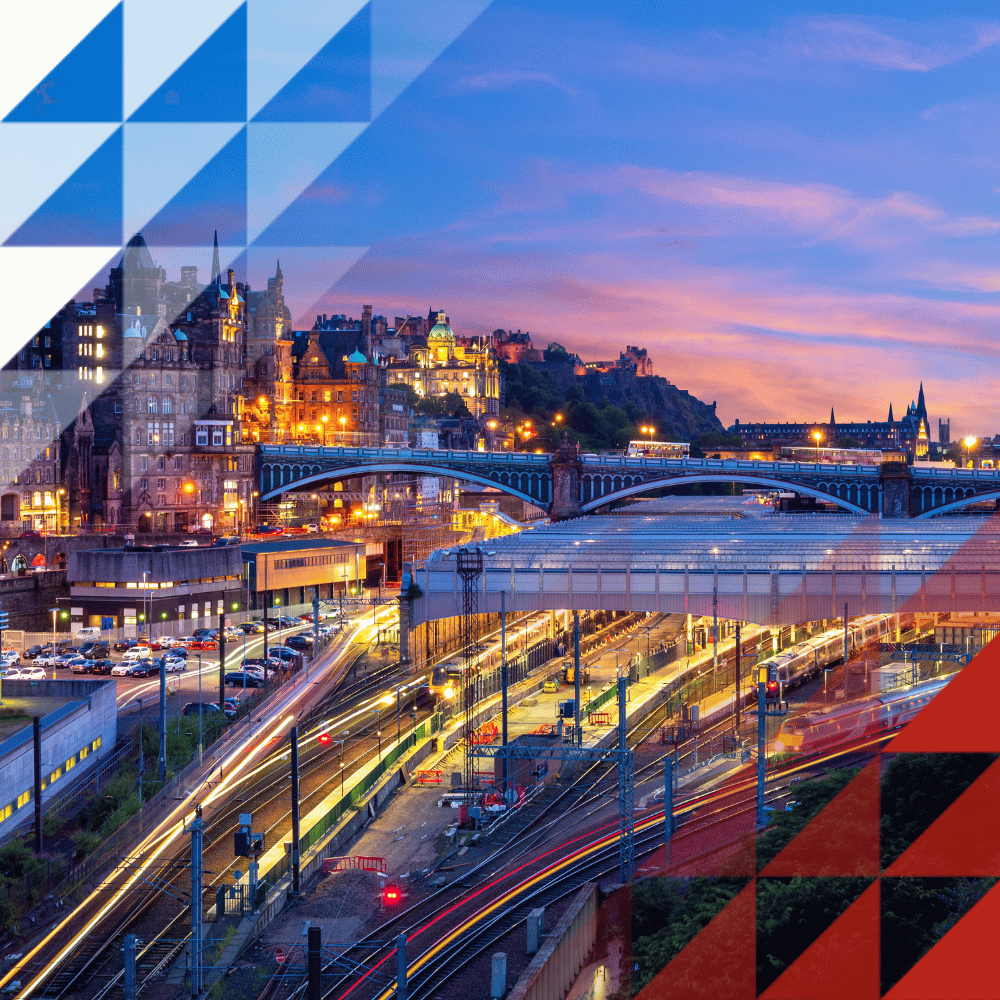 Twilight view of Edinburgh Waverley station and city skyline, with illuminated train tracks, Edinburgh Castle, and a decorative geometric overlay in the corners.