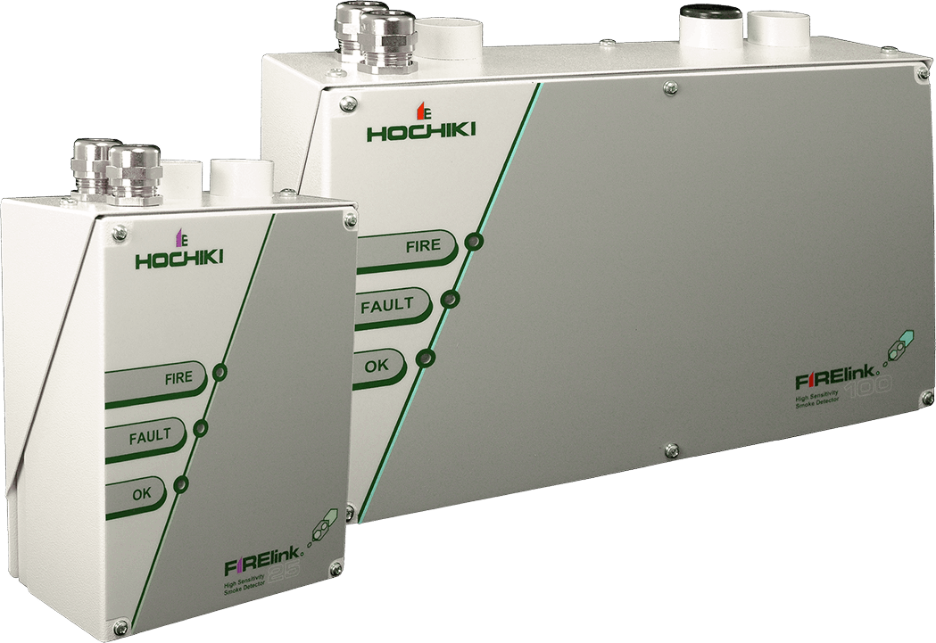 The Hochiki FIRElink 25 and FIRElink 100 high sensitivity smoke detectors, shown side by side. Both units are light grey metal enclosures featuring the Hochiki branding and three status indicators labelled Fire, Fault and OK. The larger FIRElink 100 sits behind the smaller FIRElink 25.