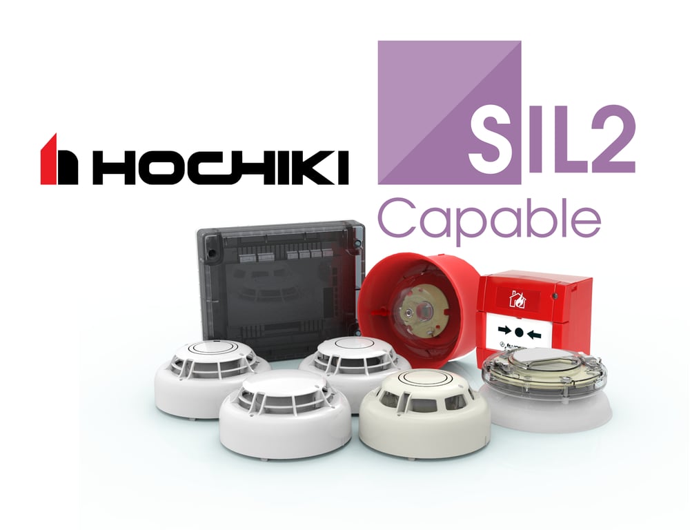 A group of Hochiki SIL2 Capable fire detection devices, including smoke detectors, a wall sounder, a manual call point, and a control module, displayed against a white background.