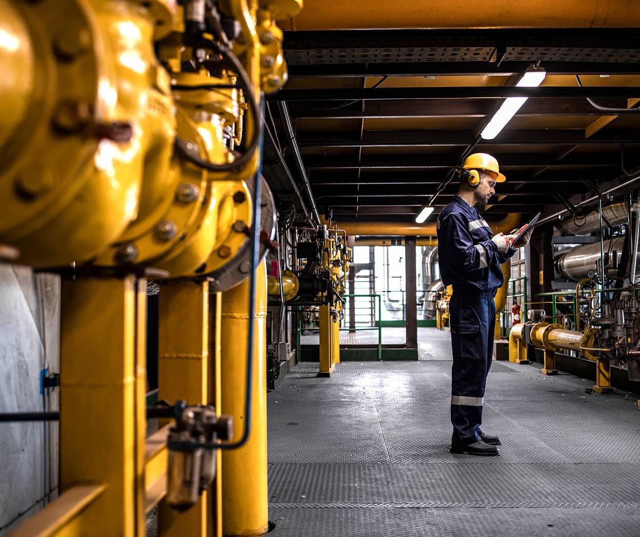 Man in safety gear in refinery