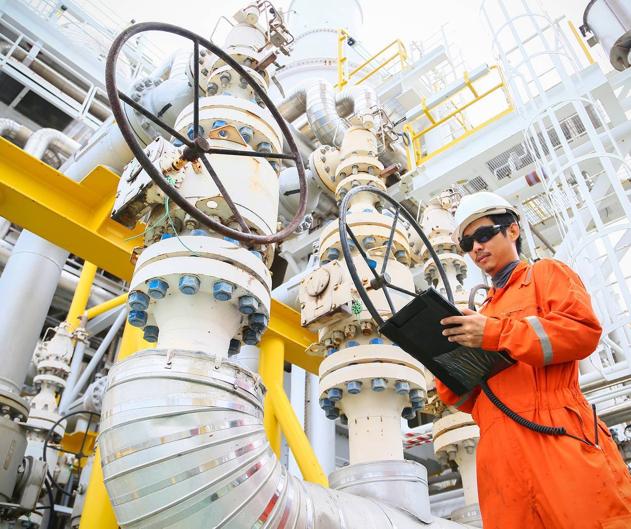 Man with clipboard on oil rig