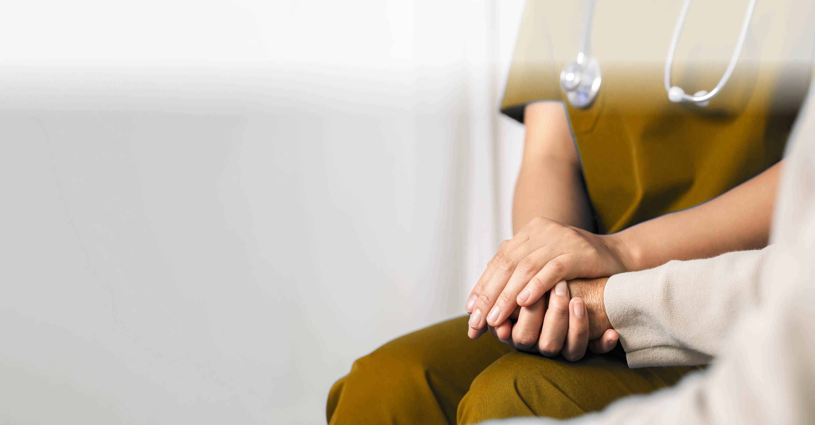 nurse holding elderly persons hand