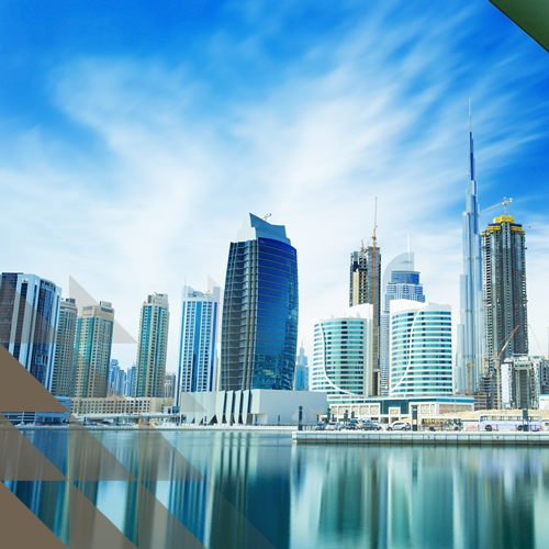 Panoramic view of Dubai's Business Bay with glass skyscrapers including the Burj Khalifa reflected in the canal waterway.