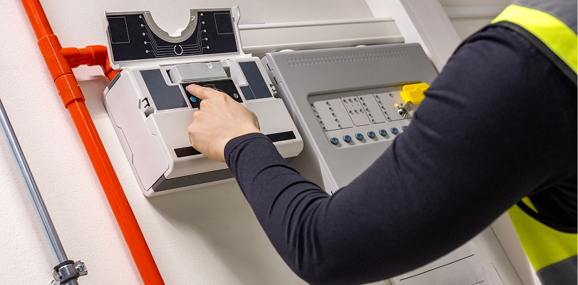 Person in hi-vis jacket pressing buttons