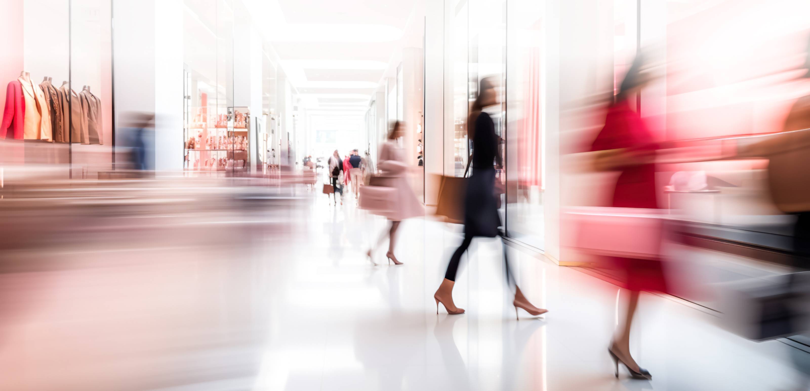 Woman walking to shop window with motion blur